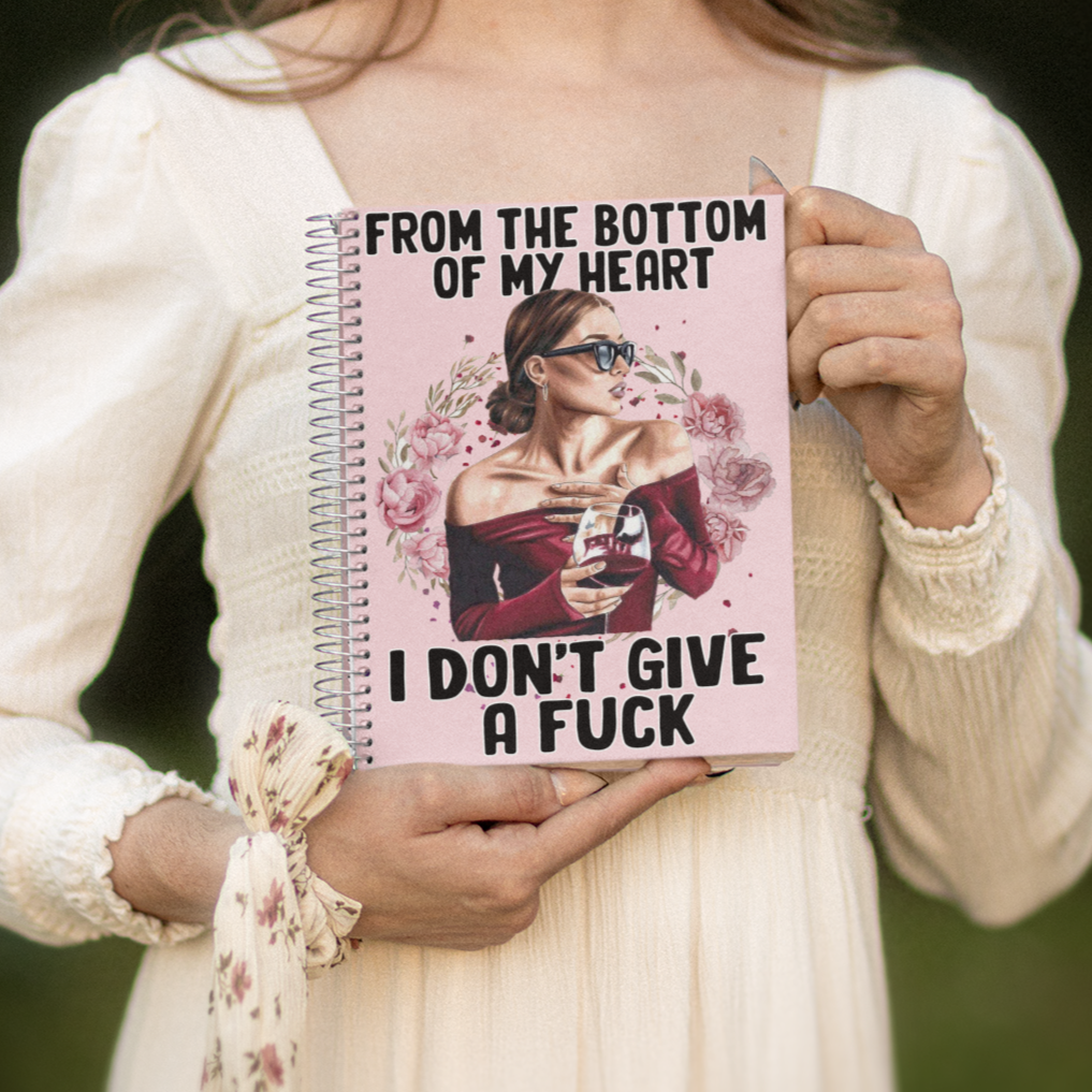 Pink Wired notebook with a woman holding a wine glass. The words "From the bottom of my Heart, I don't give a Fuck."
